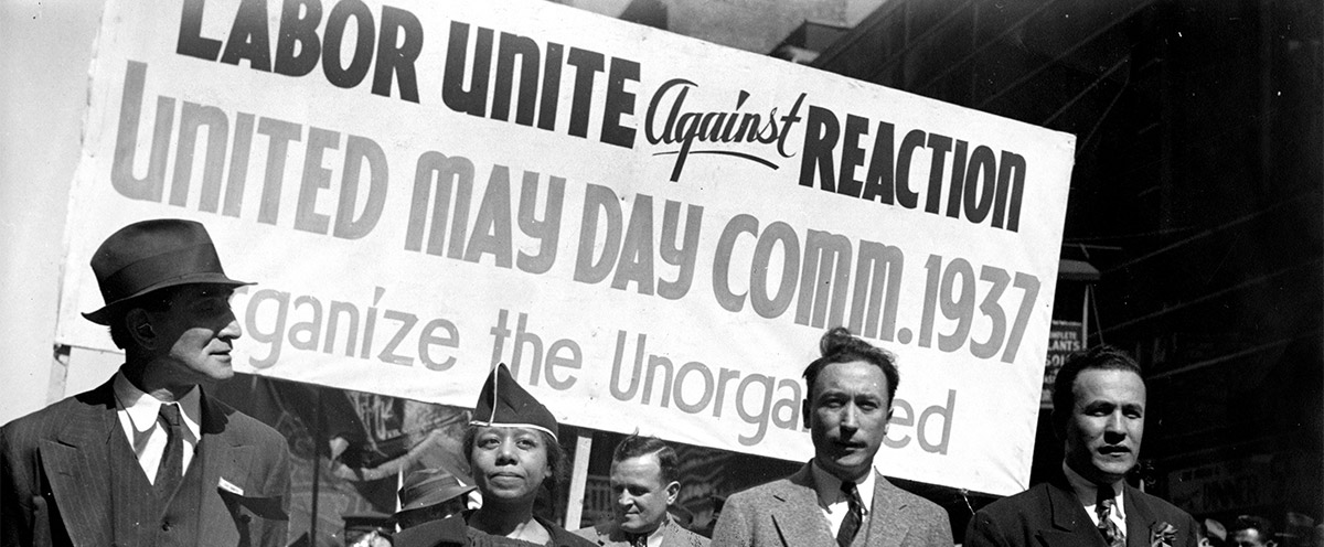 Edith Ransom and Charles Zimmerman (center) of ILGWU Local 22 march with others in the 1937 May Day parade. May 1, 1937.