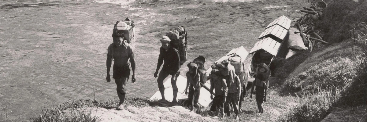 People walking towards land after disembarking from a boat